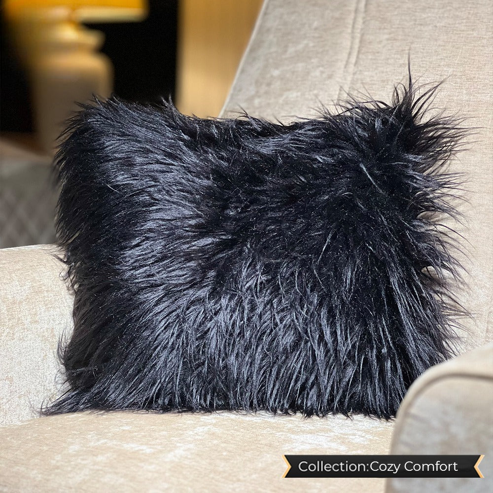 Black fuzzy cushion, soft and plush, ideal for cozy home decor.